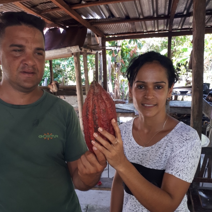 Lisbet with holding up cacao pod on her farm in Baracoa Lisbet with holding up cacao pod on her farm in Baracoa