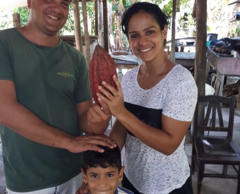 Lisbet with holding up cacao pod on her farm in Baracoa