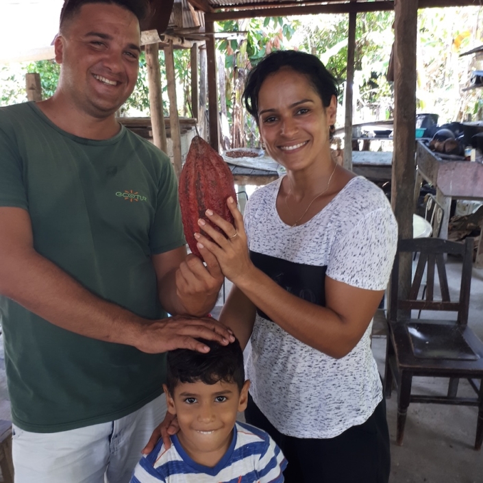 Lisbet with holding up cacao pod on her farm in Baracoa Lisbet with holding up cacao pod on her farm in Baracoa