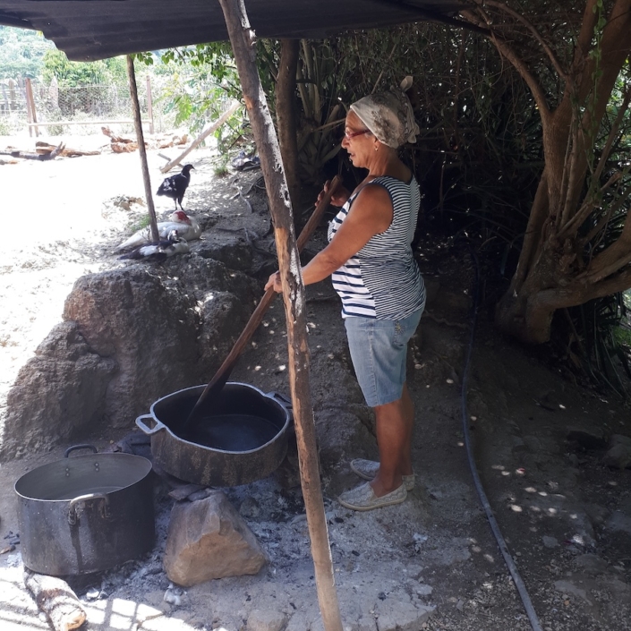 Mercedes roasting coffee on her farm near Tercer Frente
